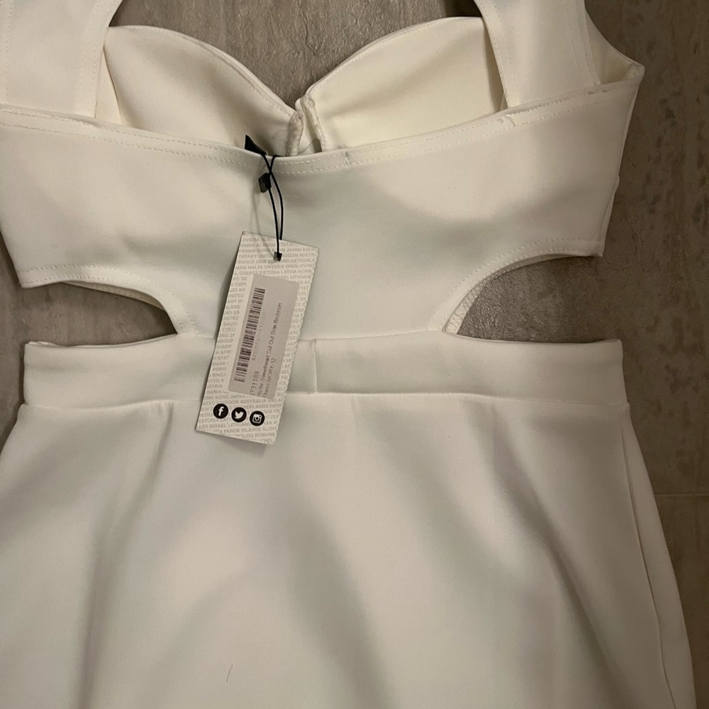 Cute cream cut out dress. Very flattering. Never worn, original tag attached.